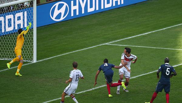 Germany's Mats Hammels heads home the only goal of the game against France.