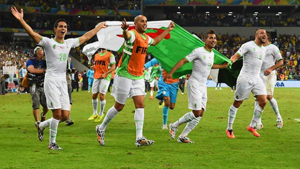 Algerian players celebrate after their draw with Russia clinched second spot in Group H.