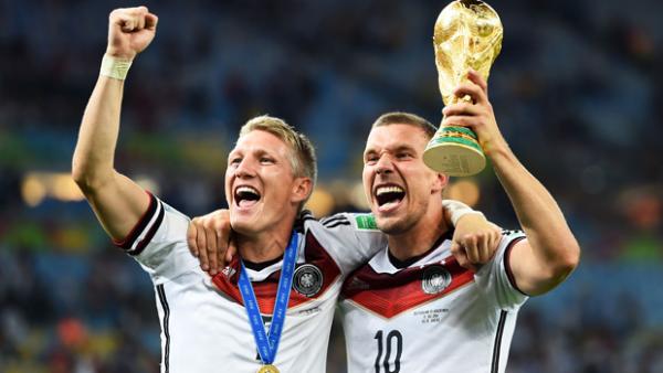 Germany's Lukas Podolski and Bastian Schweinsteiger lift the FIFA World Cup.