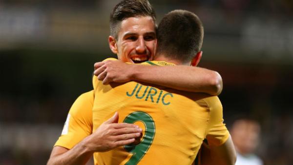 Defender Milos Degenek celebrates with Caltex Socceroos teammate Tomi Juric.