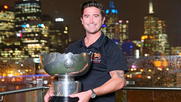 Socceroos legend Harry Kewell poses with the Asian Cup trophy.
