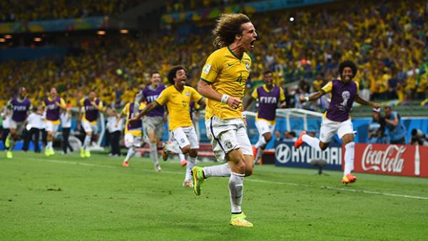 Brazilian defender David Luiz celebrates scoring against Colombia.