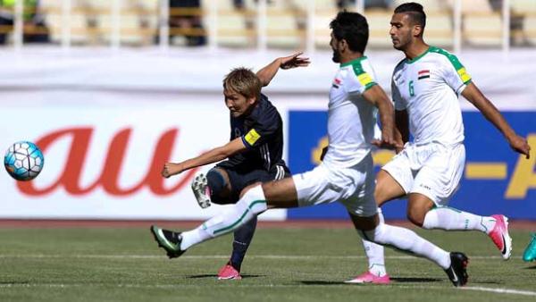 Genki Haraguchi tries a shot for Japan against Iraq.