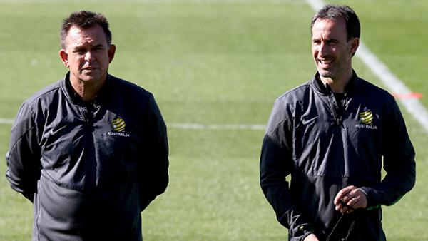 Socceroos goalkeeping coach Tony Franken and assistant coach Aurelio Vidmar watch the team train.