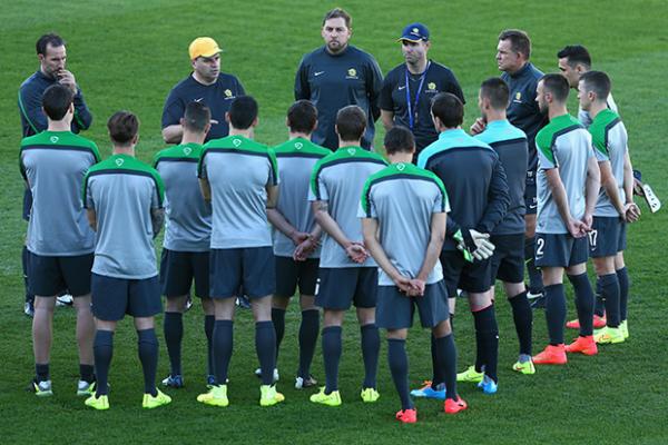 The Socceroos squad listen intently to coach Ange Postecoglou at their training camp in Gosford.