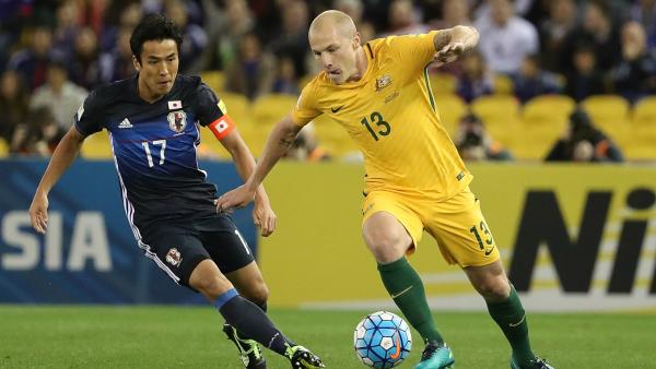 Caltex Socceroos midfielder Aaron Mooy controls the ball ahead of Japan's Makoto Hasebe.