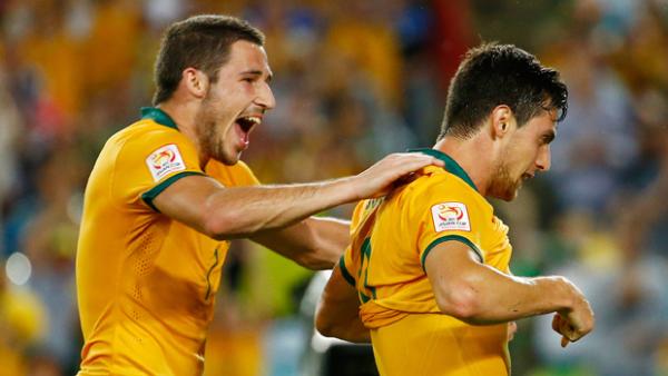 Leckie celebrates with Socceroo teammate Tomi Juric during the 4-0 win over Oman.