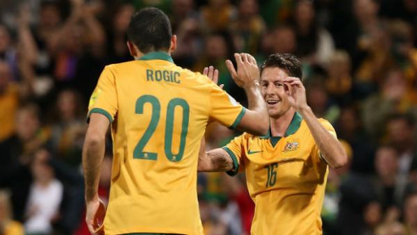 Tom Rogic celebrates scoring his first goal for the Socceroos with Nathan Burns.