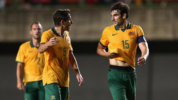Mile Jedinak chats to Mark Milligan during Australia's friendly loss to Croatia.