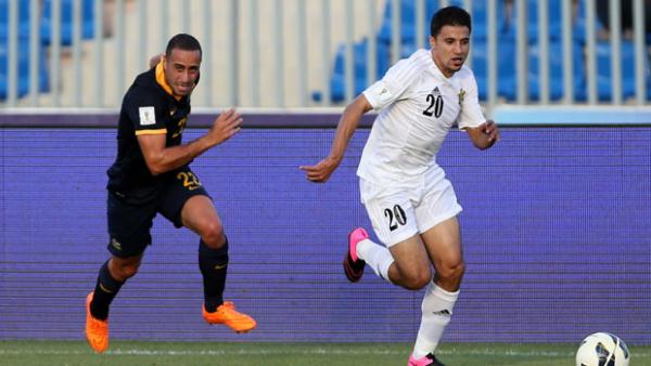 Elrich fights for the ball with Jordan attacker Hamza Aldaradreh in Amman.