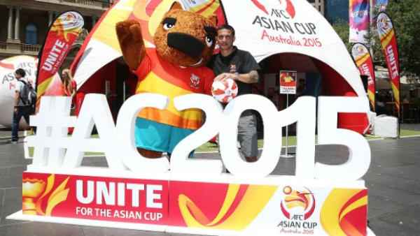 Tim Cahill with the Socceroos mascot 'Nutmeg' at the Football Fan Park in Melbourne.