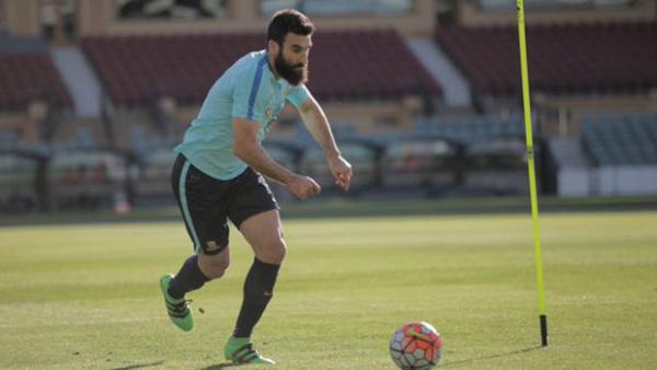 Socceroos skipper Mile Jedinak on the ball during training in Adelaide.