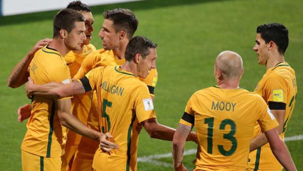 Socceroos players celebrate a goal during their 2-0 win over Iraq.