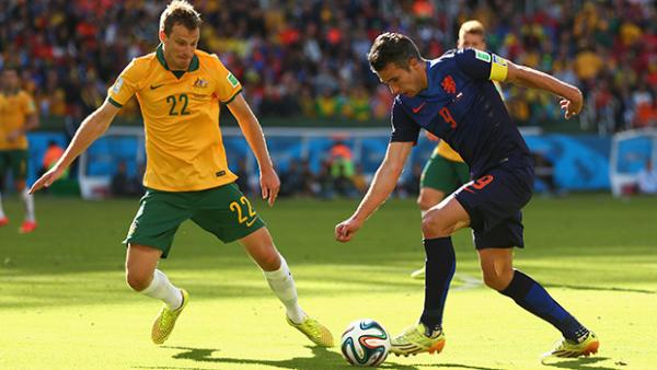 Wilkinson challenges for the ball with Dutch superstar Robin Van Persie.
