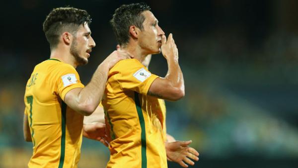 Mark Milligan celebrates a goal in World Cup qualifying against Tajikistan.