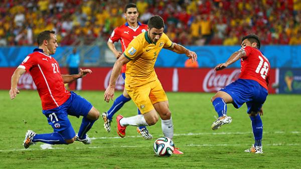Socceroo Mathew Leckie weaves his way through Chile's defence in Cuiaba.